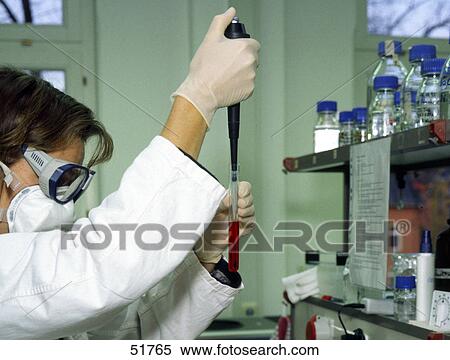 Stock Photography - Female scientist holding test tube filled with blood in laboratory . Fotosearch
