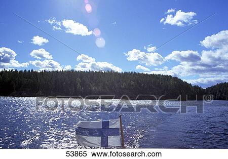Finnish flag and lake with forest in background, Finland View Large Photo Image Stock Photography - Finnish flag and lake with forest in background, Finland . Fotosearch