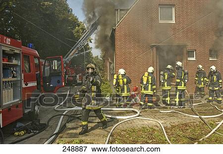 Firemen extinguishing fire in house View Large Photo Image Stock Photo - Firemen extinguishing fire in house . Fotosearch