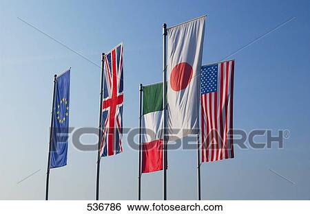 Flags of different countries against blue sky View Large Photo Image Stock Photograph - Flags of different countries against blue sky . Fotosearch