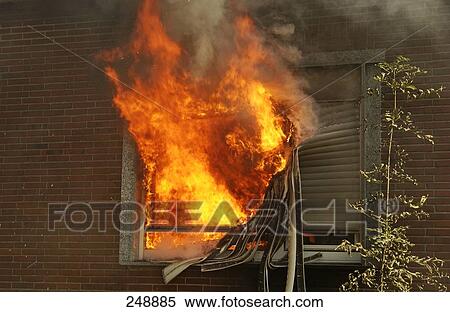 Stock Photography - Flames coming out of broken window of house . Fotosearch