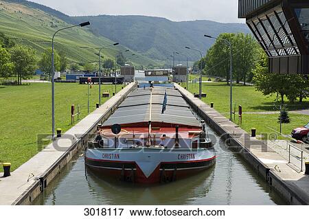 Stock Photo - Freight ship in the lock of Detzem, Rhineland-Palatinate, Germany, vanishing point . Fotosearch