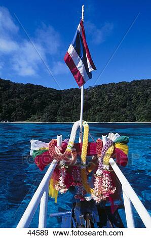 Stock Photo - Garlands and flag on a ships bow, Similan Islands, Thailand . Fotosearch