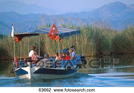 Group of people traveling on boat in river, Mugla, Turkey View Large Photo Image Stock Image - Group of people traveling on boat in river, Mugla, Turkey . Fotosearch