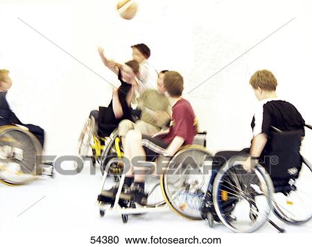 Stock Image - Handicapped teenage boys playing basketball . Fotosearch