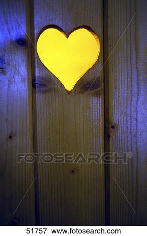 Stock Photo - Heart cutout on wooden plank . Fotosearch