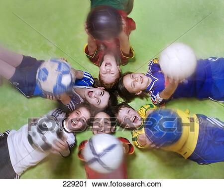 High angle view of boys holding soccer balls View Large Photo Image Stock Image - High angle view of boys holding soccer balls . Fotosearch