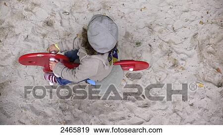 High angle view of child sitting on rocker bicycle View Large Photo Image Stock Photo - High angle view of child sitting on rocker bicycle . Fotosearch
