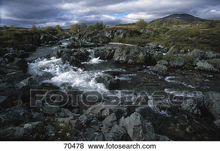 High angle view of river flowing through rocks View Large Photo Image Stock Photo - High angle view of river flowing through rocks . Fotosearch