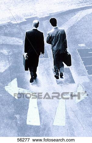 High angle view of two businessmen walking with briefcases on street View Large Photo Image Stock Photo - High angle view of two businessmen walking with briefcases on street . Fotosearch