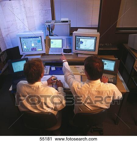 High angle view of two men working on computers in control room View Large Photo Image Stock Image - High angle view of two men working on computers in control room . Fotosearch