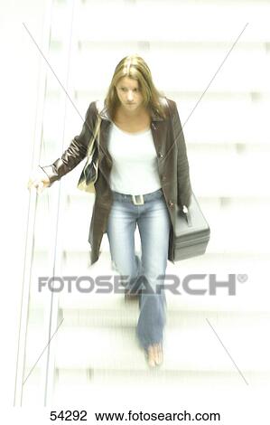 High angle view of young woman walking down stairs View Large Photo Image Stock Image - High angle view of young woman walking down stairs . Fotosearch