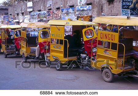 Picture - Jinrikisha parked in row, Sialkot, Pakistan . Fotosearch