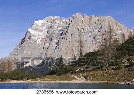 Stock Photograph - Lake in front of mountain, Seebensee, Mt Zugspitze, Germany . Fotosearch