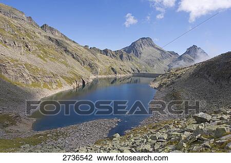 Lake surrounded by mountains, Reisseckgruppe, Carinthia, Austria View Large Photo Image Stock Image - Lake surrounded by mountains, Reisseckgruppe, Carinthia, Austria . Fotosearch