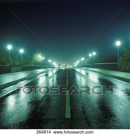 Lanterns lit up at night along road View Large Photo Image Picture - Lanterns lit up at night along road . Fotosearch