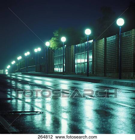 Lanterns lit up at night along road View Large Photo Image Stock Image - Lanterns lit up at night along road . Fotosearch