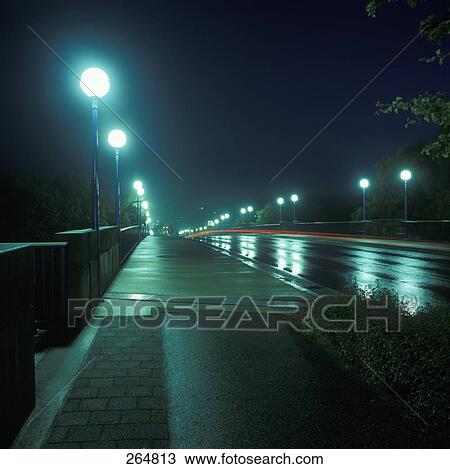 Lanterns lit up at night along road View Large Photo Image Stock Image - Lanterns lit up at night along road . Fotosearch