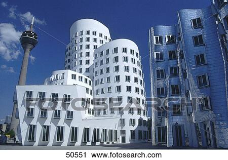 Stock Image - Low angle view of communication tower with office buildings, Neuer Zollhof, Dusseldorf, North Rhine-Westphalia, Germany . Fotosearch