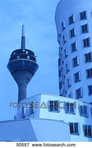 Stock Photo - Low angle view of communication tower with office buildings, Neuer Zollhof, Dusseldorf, North Rhine-Westphalia, Germany . Fotosearch