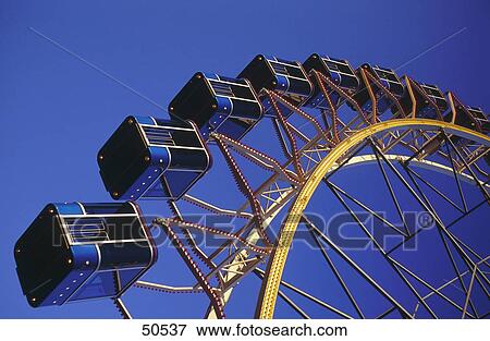 Stock Photo - Low angle view of Ferris wheel . Fotosearch