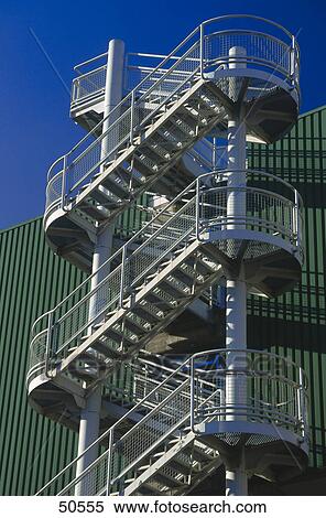 Stock Photography - Low angle view of fire escape stairs at industrial hall . Fotosearch
