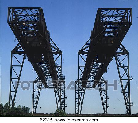 Low angle view of rusty cranes against blue sky, Germany View Large Photo Image Stock Photography - Low angle view of rusty cranes against blue sky, Germany . Fotosearch