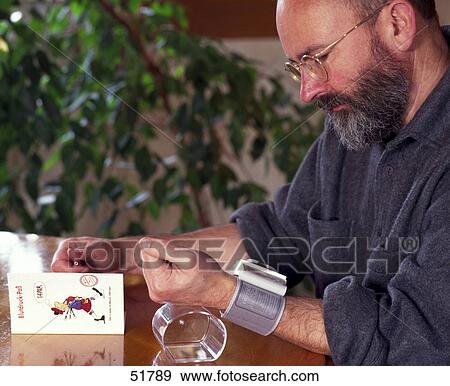 Man checking blood pressure View Large Photo Image Stock Photo - Man checking blood pressure . Fotosearch