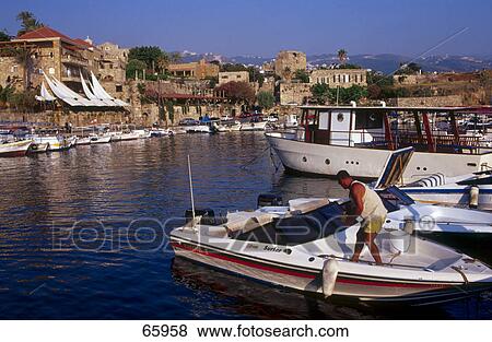 Man in speed boat, Byblos, Mount Lebanon Governorate, Lebanon View Large Photo Image Stock Photo - Man in speed boat, Byblos, Mount Lebanon Governorate, Lebanon . Fotosearch