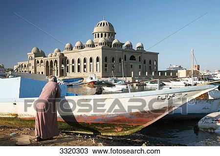 Men at a fishing harbour, mosque in the background, Hurghada, Egypt View Large Photo Image Stock Image - Men at a fishing harbour, mosque in the background, Hurghada, Egypt . Fotosearch