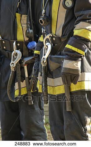 Stock Image - Midsection view of firemen in protective clothing . Fotosearch