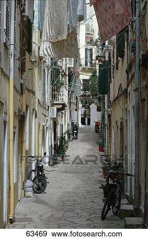 Mopeds parked against walls in empty alley, Corfu, Ionian Islands, Greece View Large Photo Image Stock Photo - Mopeds parked against walls in empty alley, Corfu, Ionian Islands, Greece . Fotosearch