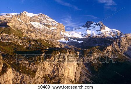 Stock Photo - Mountain range at sunset, Swiss Alps, Switzerland . Fotosearch