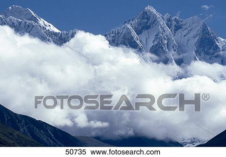 Mountains surrounded by clouds, Mt Everest, Himalaya Range, Nepal View Large Photo Image Stock Photography - Mountains surrounded by clouds, Mt Everest, Himalaya Range, Nepal . Fotosearch