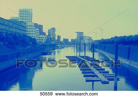 Stock Photo - Office buildings on riverbank, River Rhine, Neuer Zollhof, Dusseldorf, North Rhine-Westphalia, Germany . Fotosearch