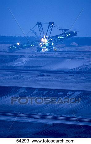 Paddlewheel excavator lit up at open pit mine, Brandenburg, Germany View Large Photo Image Stock Image - Paddlewheel excavator lit up at open pit mine, Brandenburg, Germany . Fotosearch