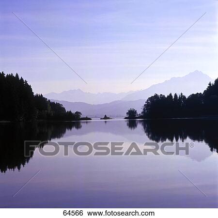 Panoramic view of mountain range reflected in lake, Bavaria, Germany View Large Photo Image Stock Photograph - Panoramic view of mountain range reflected in lake, Bavaria, Germany . Fotosearch