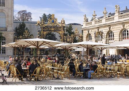 Stock Image - People at sidewalk cafe, Place Stanislas, Nancy, Meurthe et Moselle, France . Fotosearch