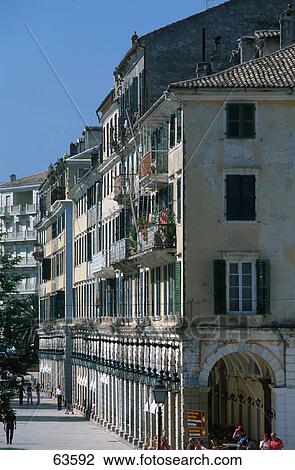 Stock Image - People in front of buildings in town, Corfu, Ionian Islands, Greece . Fotosearch
