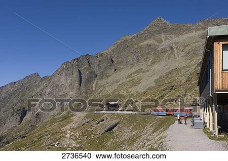 Stock Image - People standing outside railway station, Reisseckgruppe, Reisseckbahn, Carinthia, Austria . Fotosearch