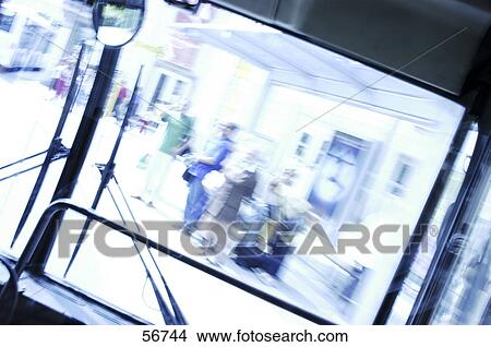 Picture - People waiting at bus stop viewed through window bus . Fotosearch