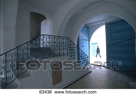 Person walking on road viewed from open door of hotel, Hotel Erriadh, Houmt Souk, Tunisia View Large Photo Image Stock Photograph - Person walking on road viewed from open door of hotel, Hotel Erriadh, Houmt Souk, Tunisia . Fotosearch
