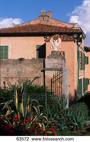 Plants near open gate of building, Mansion Dei Mulini, Elba Island, Tuscany, Italy View Large Photo Image Stock Image - Plants near open gate of building, Mansion Dei Mulini, Elba Island, Tuscany, Italy . Fotosearch