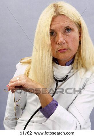 Stock Image - Portrait of female doctor with stethoscope around her neck . Fotosearch