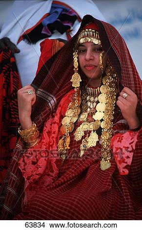 Picture - Portrait of young woman in traditional clothing, Tunisia . Fotosearch