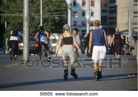 Rear view of couple inline skating on street, Zurich, Switzerland View Large Photo Image Stock Photography - Rear view of couple inline skating on street, Zurich, Switzerland . Fotosearch