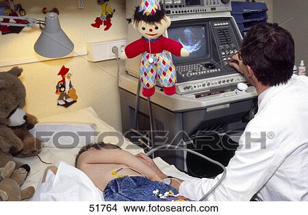 Picture - Rear view of male doctor examining ultrasound of boy . Fotosearch