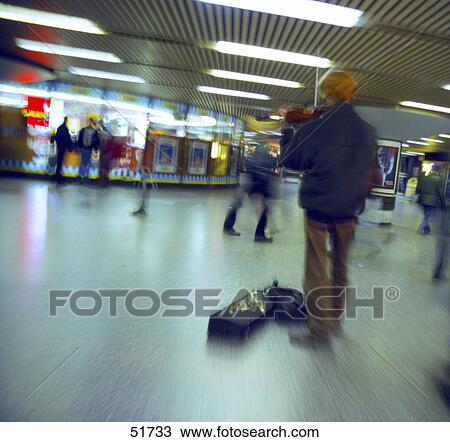 Stock Image - Rear view of man playing violin . Fotosearch