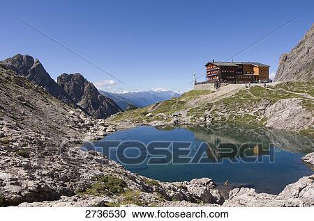 Reflection of building in lake, Lienzer Dolomiten, Lienz, Tyrol, Austria View Large Photo Image Stock Image - Reflection of building in lake, Lienzer Dolomiten, Lienz, Tyrol, Austria . Fotosearch