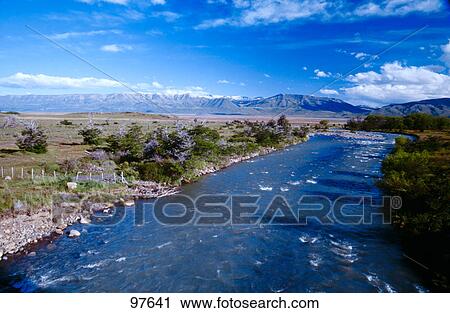 River flowing through landscape View Large Photo Image Stock Image - River flowing through landscape . Fotosearch